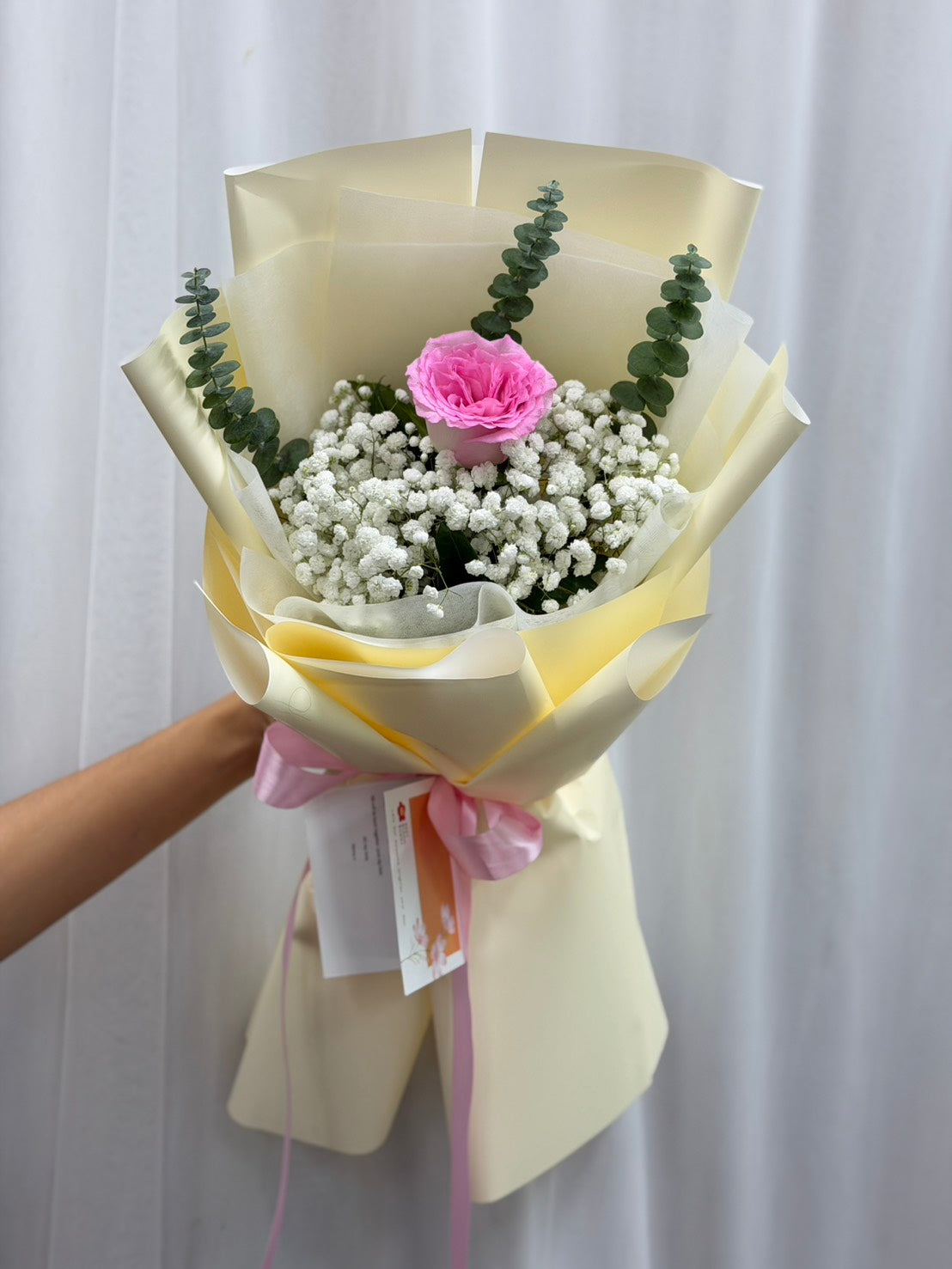 Single pink rose bouquet by BestBloomBuddy featuring a delicate pink rose with green foliage in a simple arrangement.