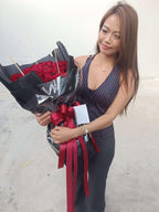 Black wrap rose bouquet with 50 red roses from BestBloomBuddy, showcasing a luxurious floral arrangement.