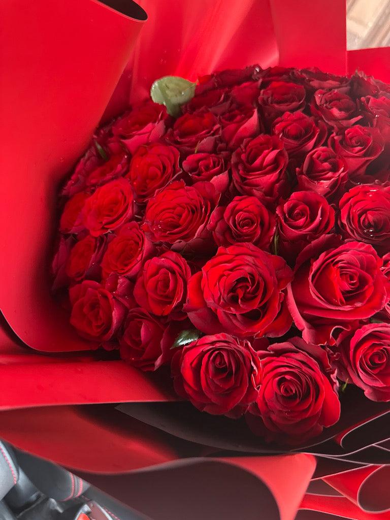 Lava Love 100 Red Roses bouquet by BestBloomBuddy, fresh red roses arranged in a beautiful floral display.