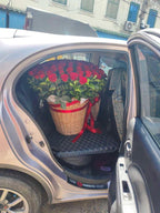 Red roses in a round flower basket from BestBloomBuddy, showcasing a beautiful bouquet of one hundred roses for special occasions.