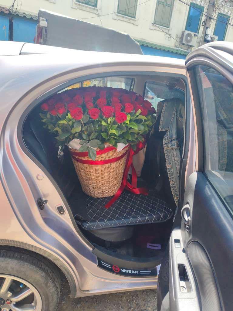 Red roses in a round flower basket from BestBloomBuddy, showcasing a beautiful bouquet of one hundred roses for special occasions.