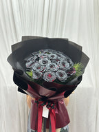 Black roses bouquet with 20 crimson eclipse roses arranged naturally, showcasing dark and vibrant floral display by BestBloomBuddy.