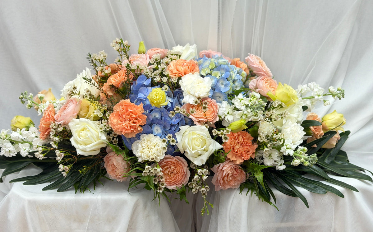 BestBloomBuddy festive flower centerpiece with peach and blue flowers, perfect for holiday celebrations or special occasions.