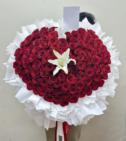 Heart of Love – 100 Red Roses Heart Bouquet with White Lily - BestBloomBuddy