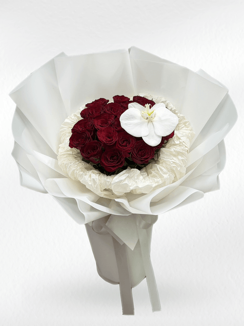 Red roses and white orchids bouquet from BestBloomBuddy, showcasing vibrant red roses with elegant white orchids.