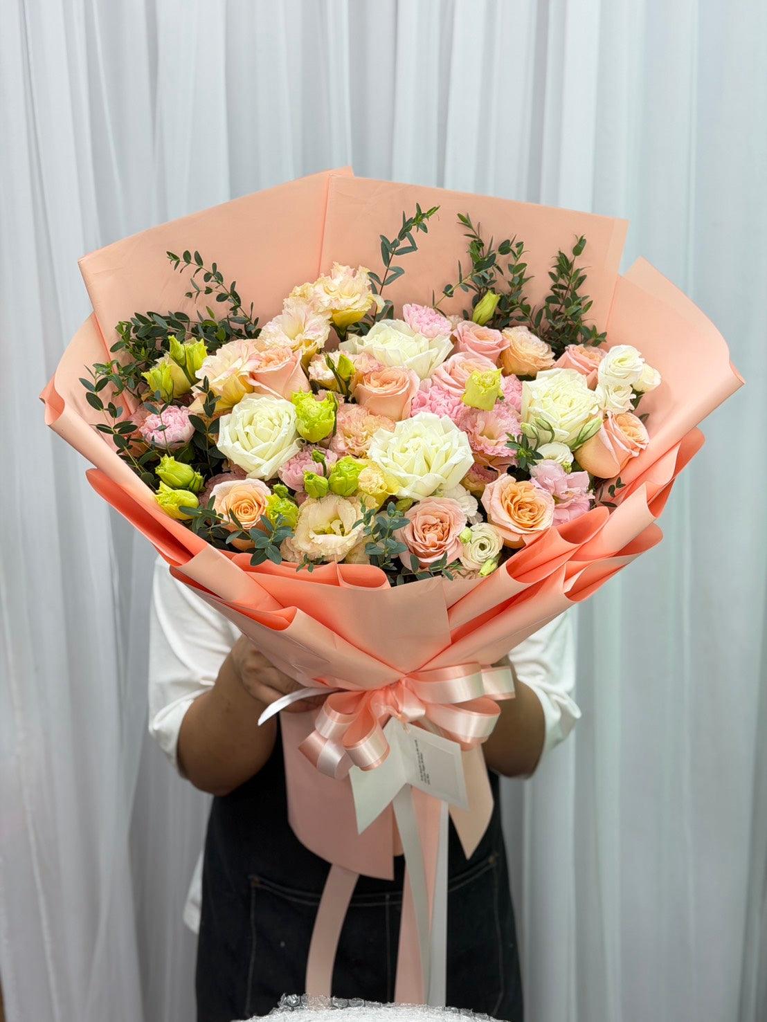 Beautiful mixed flower bouquet featuring sweet peach-colored blooms from BestBloomBuddy, arranged with vibrant seasonal flowers.