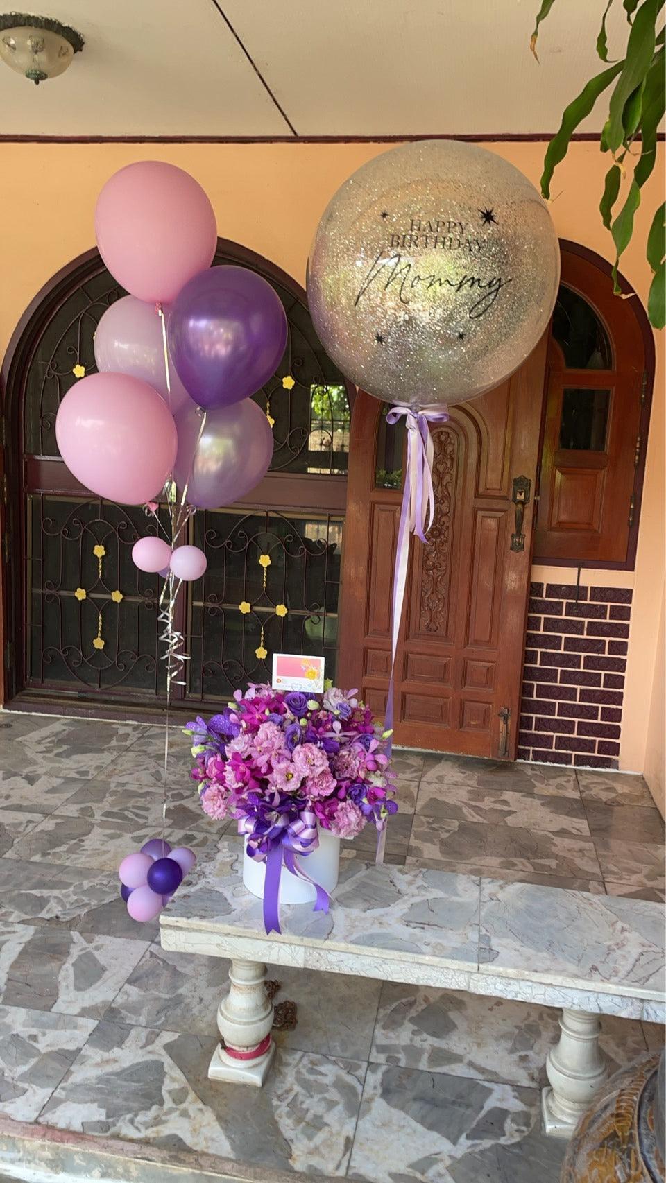 Violet orchid flower in a decorative flower box, showcasing vibrant petals and lush green leaves, from BestBloomBuddy.