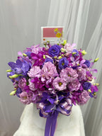 Violet orchid flower box with lush blooms in a decorative arrangement by BestBloomBuddy, perfect for elegant home decor.