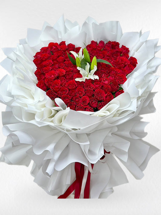 Heart of Love – 100 Red Roses Heart Bouquet with White Lily - BestBloomBuddy