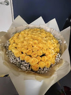 Yellow rose bouquet with 100 roses from BestBloomBuddy, arranged beautifully in a romantic floral display.