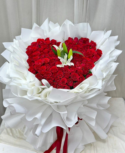 Heart of Love – 100 Red Roses Heart Bouquet with White Lily - BestBloomBuddy